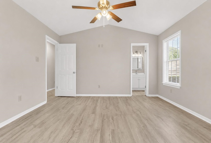 Vaulted ceiling with a brass-finish ceiling fan and light fixture