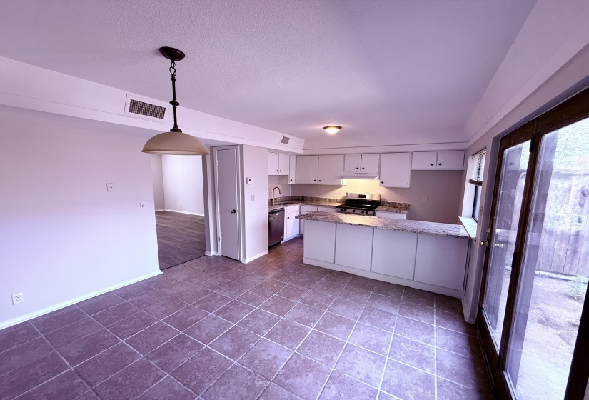 Open-concept kitchen and dining area featuring ceramic tile flooring