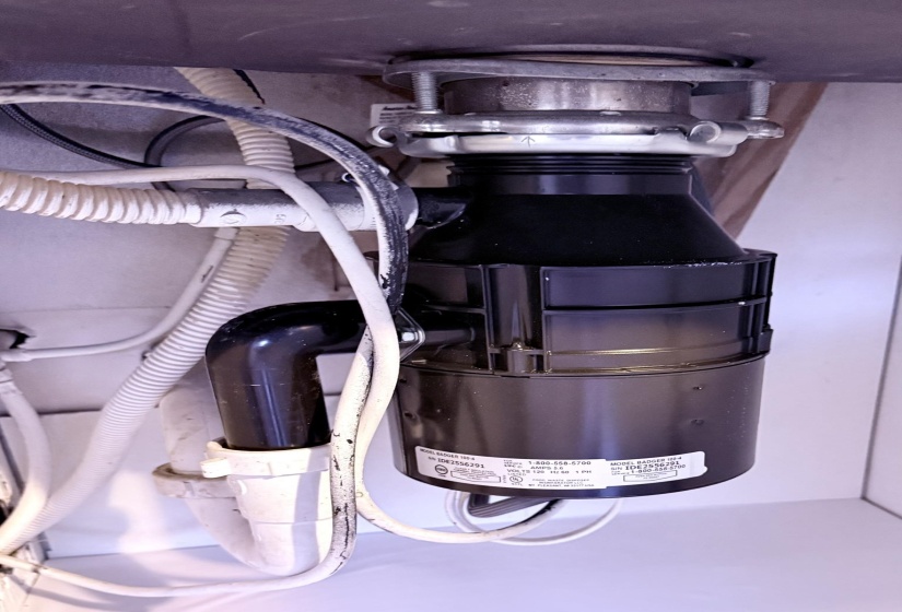 Under-sink disposal unit with associated plumbing and wiring