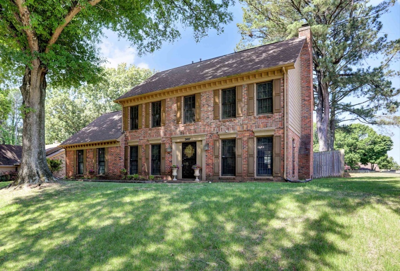 Traditional brick exterior featuring a prominent two-story structure with a side-gabled roof