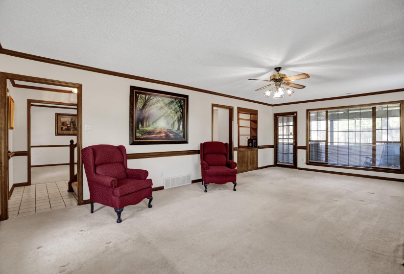 Spacious room with light-toned carpeting and wood-finish trim