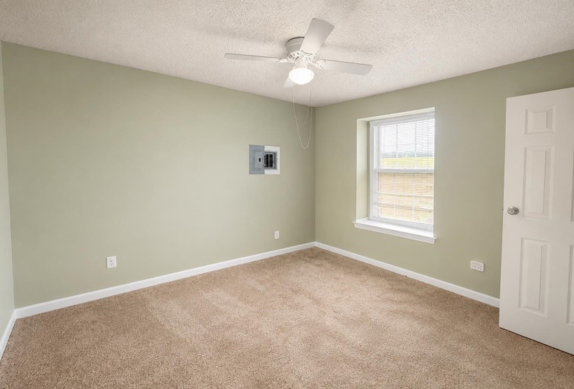 Neutral-toned carpeting paired with light green wall finishes AI-Enhanced Photo — May Not Reflect Exact Current Condition