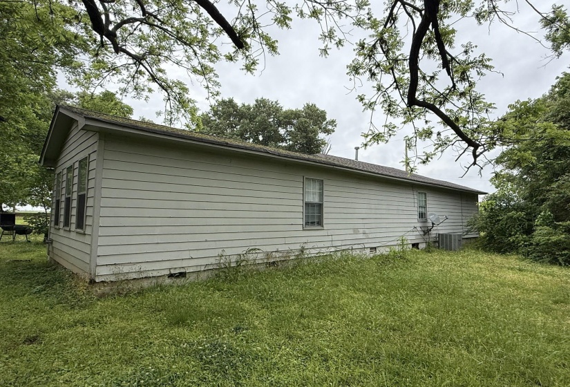 Light-colored siding exterior with a pitched roofline