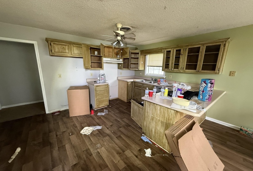 Kitchen featuring wood-finish flooring and a ceiling fan with integrated lighting
