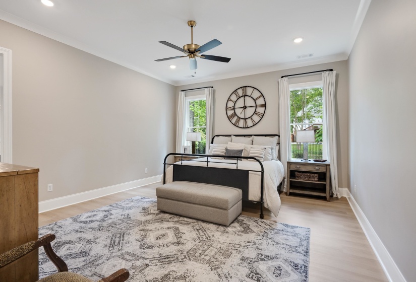Spacious room featuring wood-finish flooring and two large windows