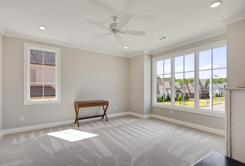 Bright interior space featuring a large three-panel window, recessed lighting, and a ceiling fan