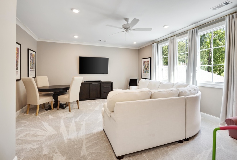 Spacious bonus room featuring a ceiling fan, recessed lighting, and crown molding