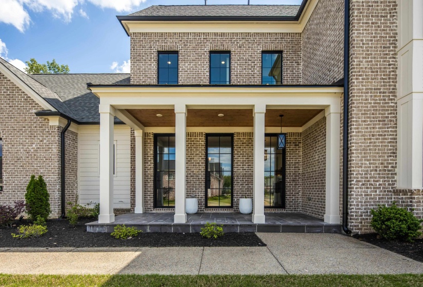 Brick facade with white siding accents and a covered front porch