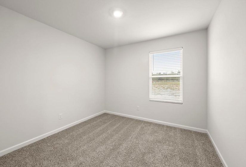 Carpeted spare room with baseboards