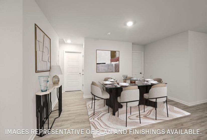 Dining room with light wood finished floors and baseboards