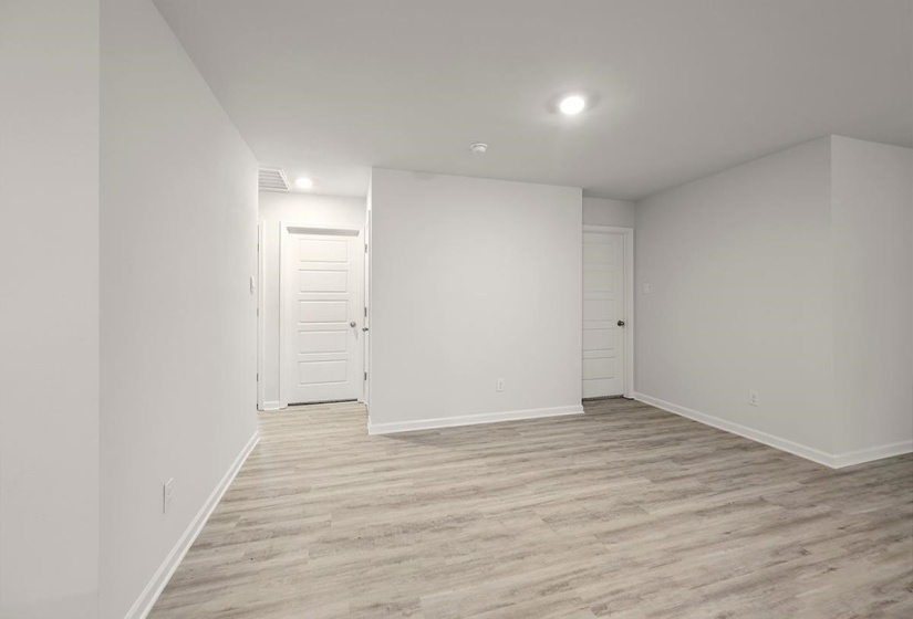 Basement featuring light wood-type flooring and baseboards