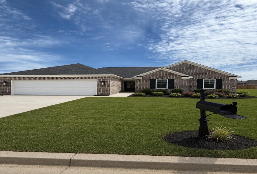 Brick exterior featuring a gabled roof and attached garage