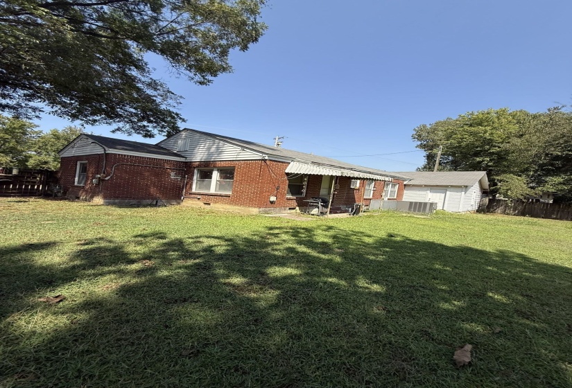 Expansive grassy yard with mature trees