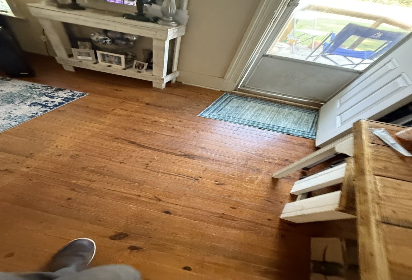 Hardwood flooring extends throughout this space, complemented by neutral wall tones