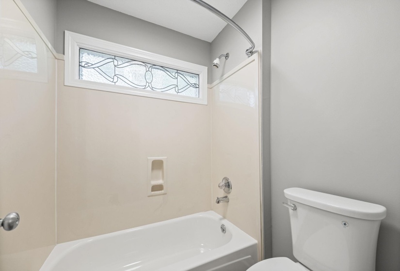 Full bath featuring shower / tub combination and toilet