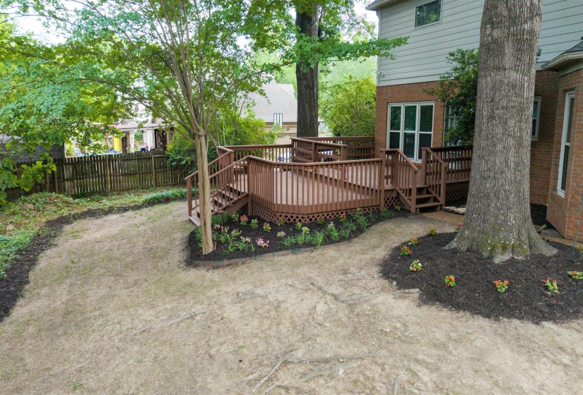 Multi-level wood deck with integrated railings and lattice skirting
