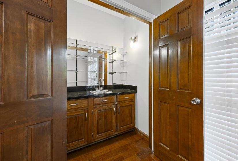 Bathroom with vanity and dark wood-type flooring