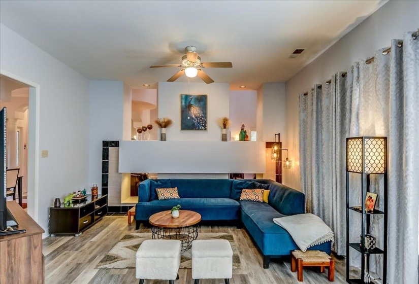 Hearth area featuring wood-finish flooring and light-toned walls
