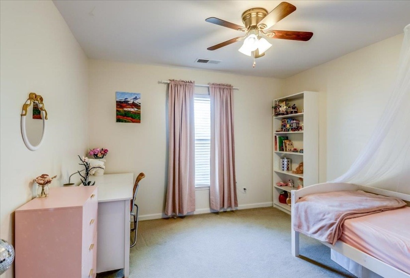 Carpeted room featuring a ceiling fan with integrated lighting, a window with blinds, and an open shelving unit