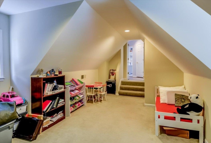 Carpeted room featuring an angled ceiling and recessed lighting