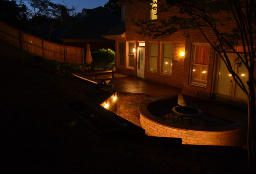 Brick exterior with multiple windows, an exterior door, and built-in lighting