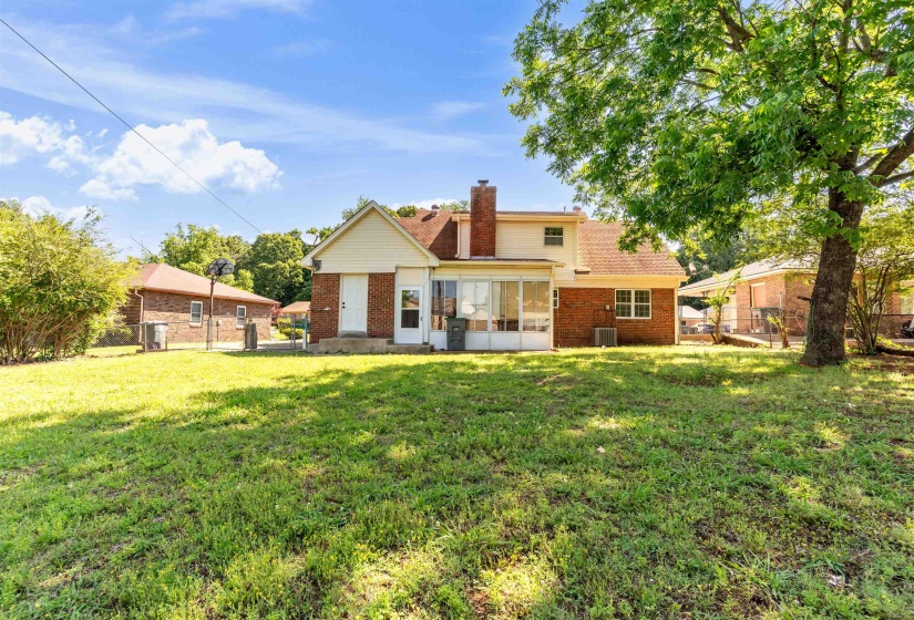 Expansive grassy yard with mature trees