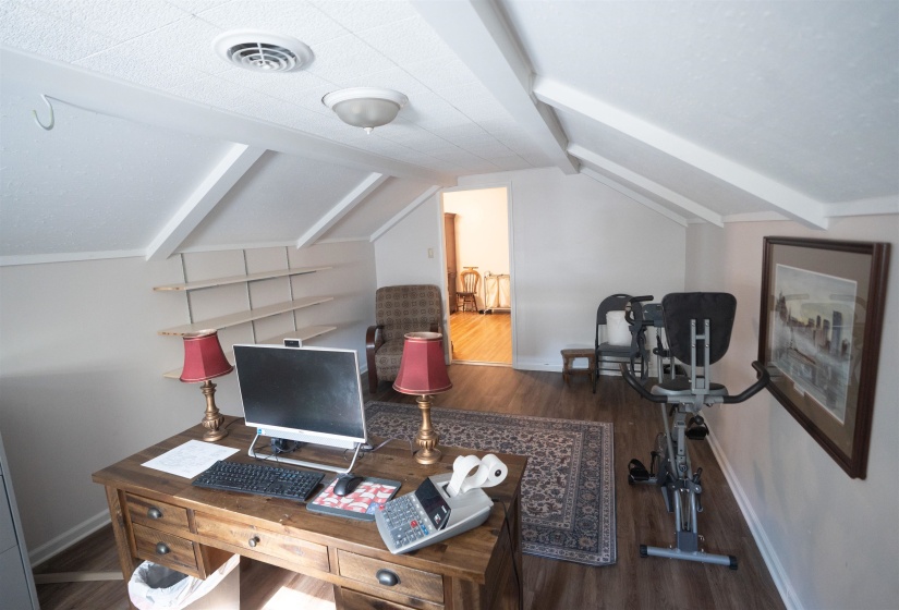 Sloped ceilings with exposed beams and recessed lighting