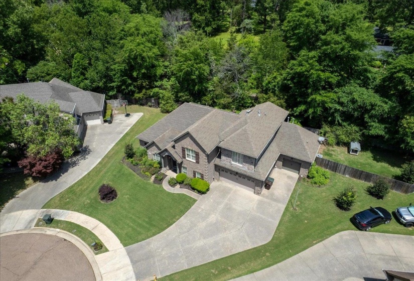 Two-story residence featuring a multi-gabled roof, a brick facade, and an attached two-car garage
