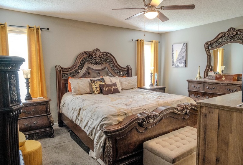 Carpeted interior room featuring light gray walls and a ceiling fan with integrated lighting