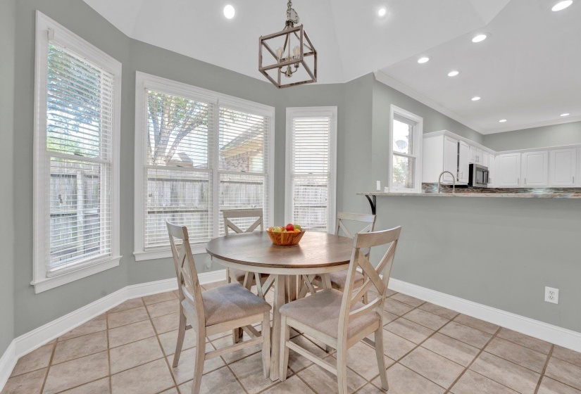 Dining area with sink and light tile patterned floors