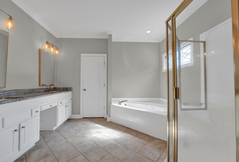 Bathroom with vanity, tile patterned flooring, independent shower and bath, and ornamental molding