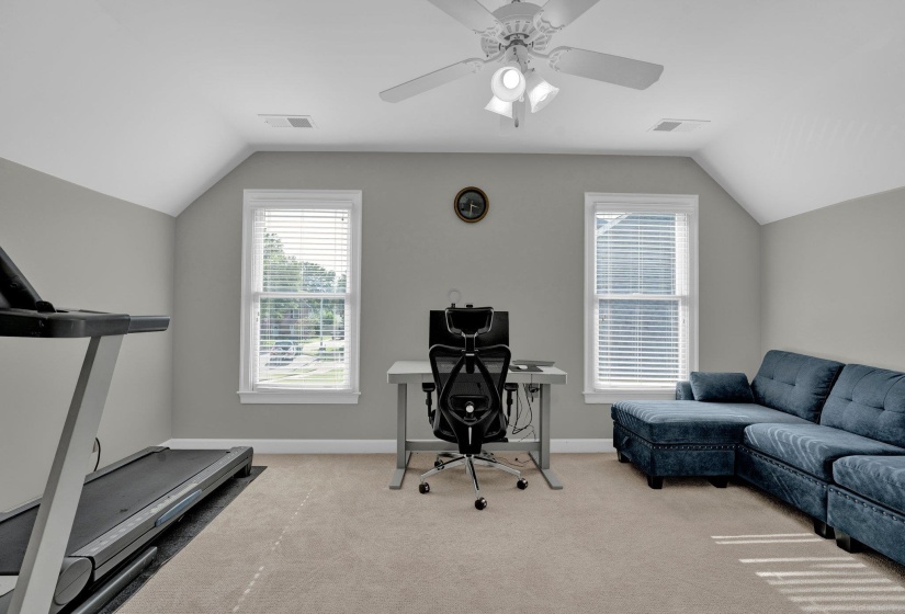 Interior space with lofted ceiling and ceiling fan