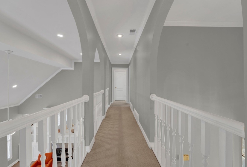 Hall featuring carpet floors and crown molding