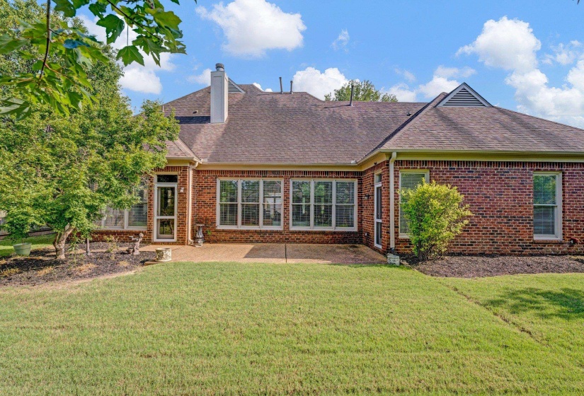 Back of property with a lawn