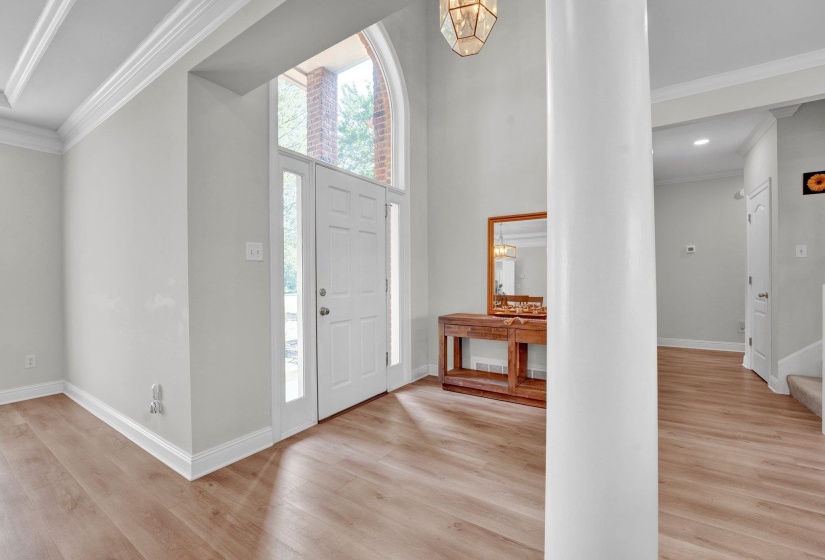 Foyer featuring light hardwood / wood-style floors and ornamental molding