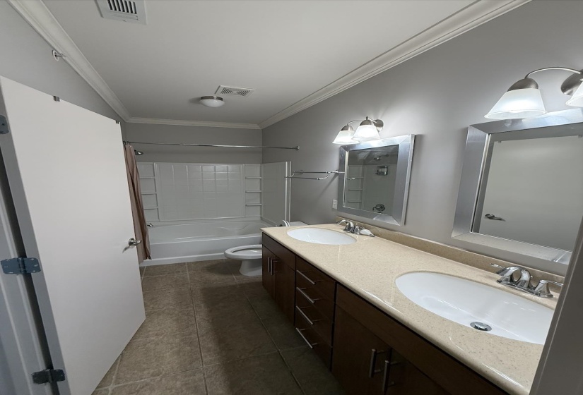Bathroom featuring double vanity and bathtub