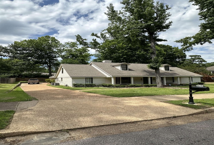 White brick exterior featuring a covered front porch with columns