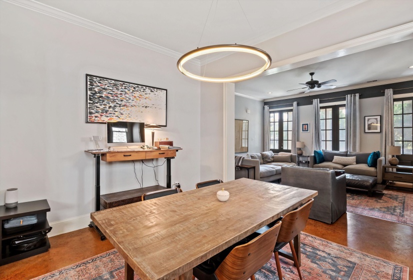 Open-concept living area with a contemporary circular chandelier and wood-finish flooring