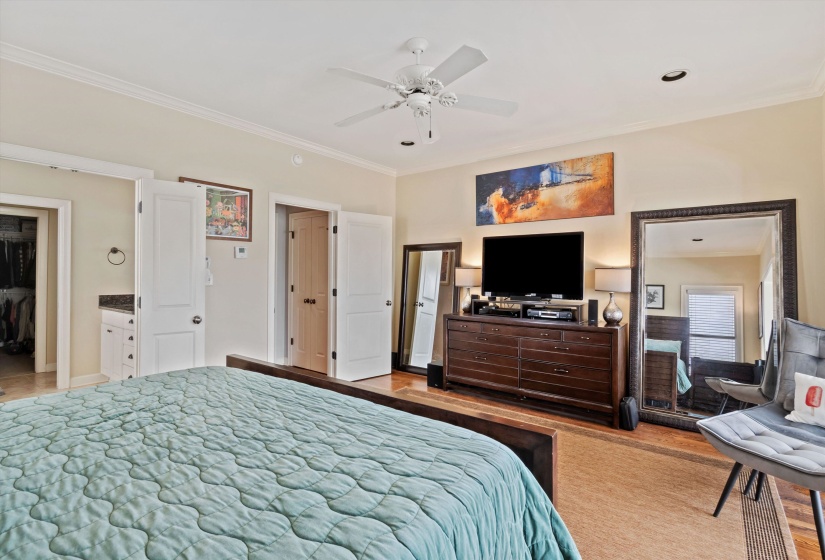 Spacious room featuring light neutral wall tones and crown molding