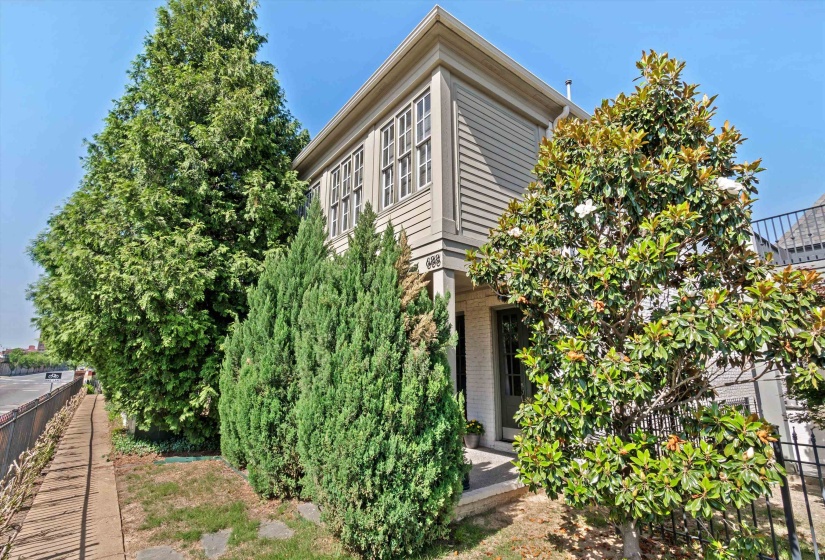 Exterior featuring horizontal siding, white brick, multi-pane windows, and a covered entry