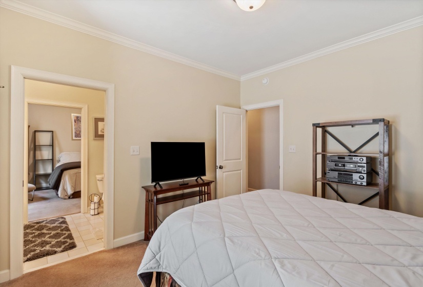 Bedroom featuring light-colored walls and crown molding