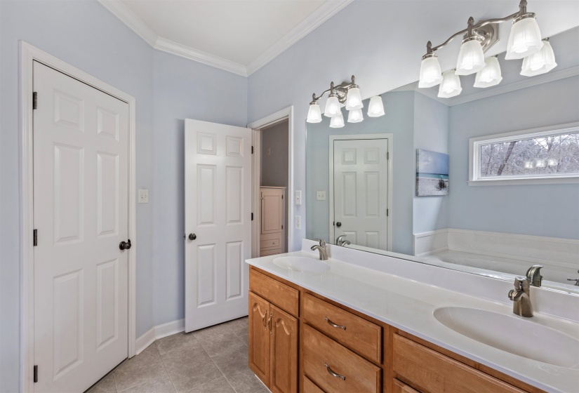 Dual vanity with integrated sinks, brushed nickel faucets, and wood-finish cabinetry
