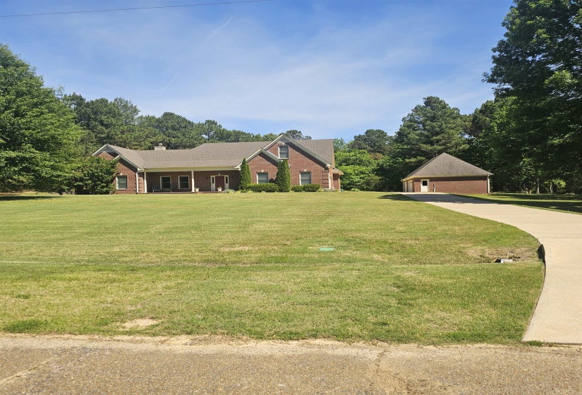 Brick exterior home featuring a covered front porch, gabled rooflines, and multiple windows
