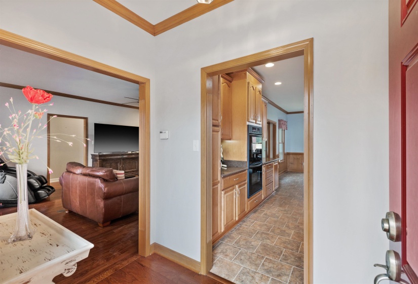 Foyer with wood-finish trim and light gray walls