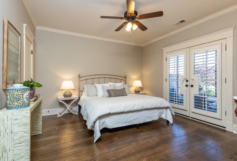 Room featuring wood-finish flooring, a ceiling fan with integrated lighting, and white crown molding
