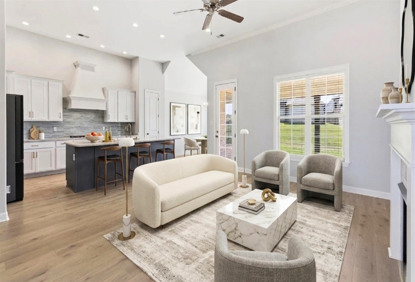 Open-concept living space featuring wood-finish flooring, a contemporary kitchen with a dark-toned island and white cabinetry, recessed lighting, and a window offering outdoor scenery