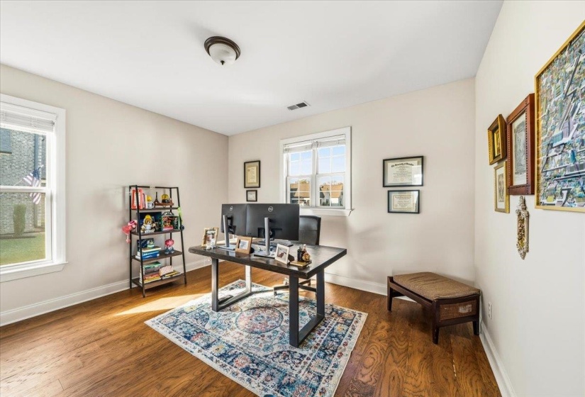 Office space featuring dark wood-style floors and baseboards