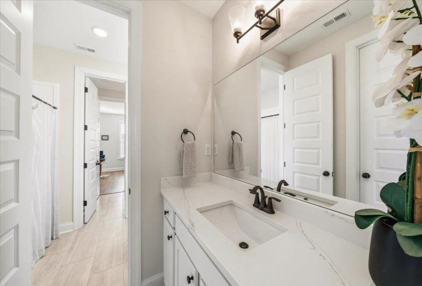Bathroom with vanity, curtained shower, and recessed lighting