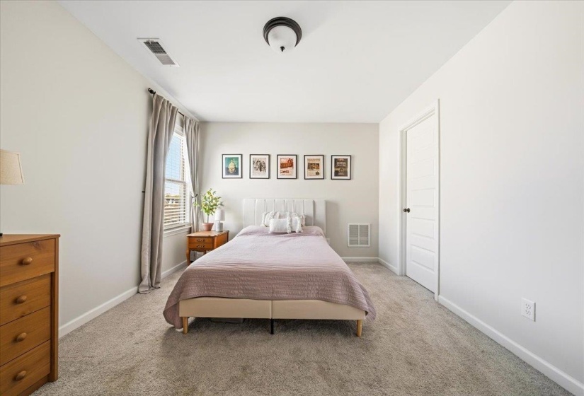 Bedroom with light carpet
