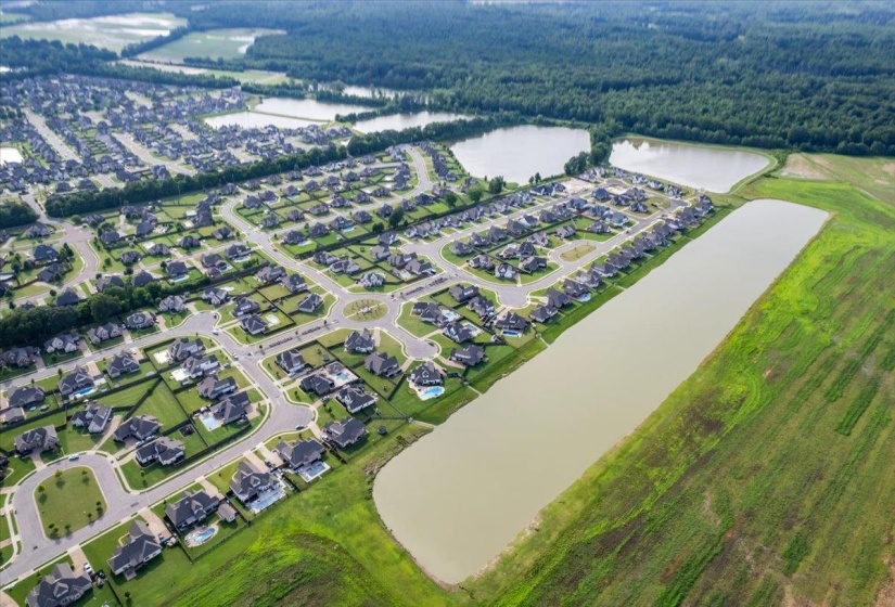Aerial view of property's location with nearby suburban area and a nearby body of water